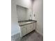 Bathroom vanity with granite countertops, white cabinets, framed mirror and tile floors at 111 Hot Springs Way, Benson, NC 27504