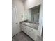 This is a bathroom vanity with granite countertops, white cabinets and tile floors at 111 Hot Springs Way, Benson, NC 27504