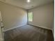This bedroom features neutral paint, carpet flooring and a window overlooking the yard at 111 Hot Springs Way, Benson, NC 27504