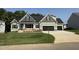 New construction featuring a spacious lawn, a black roof, and a 3-car garage at 111 Hot Springs Way, Benson, NC 27504