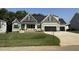 Charming home with a black roof, three-car garage, and well-maintained lawn in a suburban neighborhood at 111 Hot Springs Way, Benson, NC 27504