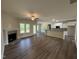 Spacious living room features a fireplace, ceiling fan, and open layout to the kitchen and dining area at 111 Hot Springs Way, Benson, NC 27504