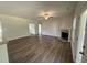 Open living area with a fireplace, ceiling fan, hardwood floors, and lots of natural light at 111 Hot Springs Way, Benson, NC 27504