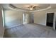 Spacious main bedroom with tray ceiling, ceiling fan, and carpet flooring at 111 Hot Springs Way, Benson, NC 27504