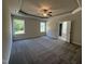 This is a spacious main bedroom with carpet floors, large windows and tray ceilings at 111 Hot Springs Way, Benson, NC 27504