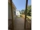 A wooden porch with wooden railings and columns at 111 Hot Springs Way, Benson, NC 27504