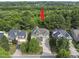 Bird's eye view of a well-maintained home with a long driveway in a lush setting at 1133 Heritage Greens Dr, Wake Forest, NC 27587