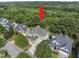 Aerial view of a beautiful home surrounded by mature trees in a peaceful neighborhood at 1133 Heritage Greens Dr, Wake Forest, NC 27587