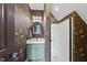 Bathroom with decorative wallpaper, single sink vanity and shower at 1133 Heritage Greens Dr, Wake Forest, NC 27587