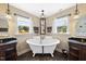 Bright bathroom with dual sink vanities, claw foot tub, decorative lighting and beautiful windows at 1133 Heritage Greens Dr, Wake Forest, NC 27587