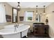 Elegant bathroom with clawfoot tub, decorative chandelier, and dark wood vanity at 1133 Heritage Greens Dr, Wake Forest, NC 27587