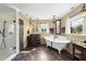 Bathroom with glass enclosed shower, claw foot tub, stylish decor, tiled floor and vintage-look sink at 1133 Heritage Greens Dr, Wake Forest, NC 27587