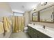 Bright bathroom with double sinks, framed mirrors, and shower with curtain at 1133 Heritage Greens Dr, Wake Forest, NC 27587
