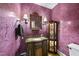 Stylish powder room with textured walls, decorative mirror, and unique vanity at 1133 Heritage Greens Dr, Wake Forest, NC 27587