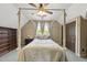 A bedroom featuring a four poster bed with a decorative ceiling fan and a beautiful wood dresser at 1133 Heritage Greens Dr, Wake Forest, NC 27587
