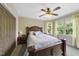 Bedroom with wood bed frame, ceiling fan, large windows, and carpet at 1133 Heritage Greens Dr, Wake Forest, NC 27587