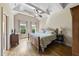 Spacious bedroom featuring a wood bed frame, tray ceilings, and hardwood floors at 1133 Heritage Greens Dr, Wake Forest, NC 27587