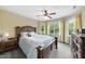 Bright bedroom featuring a wooden bed frame, ceiling fan, and large windows at 1133 Heritage Greens Dr, Wake Forest, NC 27587