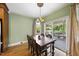 Charming dining room with hardwood floors, elegant lighting, and access to the patio at 1133 Heritage Greens Dr, Wake Forest, NC 27587