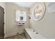 Cozy entryway with a built-in bench, storage, and a unique round window adding charm at 1133 Heritage Greens Dr, Wake Forest, NC 27587