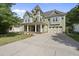 Beautiful two-story home with a well-manicured lawn and a spacious driveway leading to an attached garage at 1133 Heritage Greens Dr, Wake Forest, NC 27587