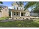 Inviting two-story home featuring a classic covered front porch, columns, and well-maintained landscaping at 1133 Heritage Greens Dr, Wake Forest, NC 27587