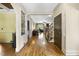 Elegant foyer featuring gleaming hardwood floors, arched doorways, and classic details at 1133 Heritage Greens Dr, Wake Forest, NC 27587
