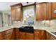 Well appointed kitchen features wood cabinets, granite counters, tile backsplash and a farmhouse sink at 1133 Heritage Greens Dr, Wake Forest, NC 27587