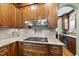 Gourmet kitchen featuring granite countertops, a gas range, and ample cabinet space at 1133 Heritage Greens Dr, Wake Forest, NC 27587