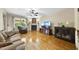 Bright living room featuring a fireplace, hardwood floors, and plenty of seating at 1133 Heritage Greens Dr, Wake Forest, NC 27587