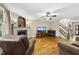 Open-concept living room with fireplace, hardwood floors, and staircase access at 1133 Heritage Greens Dr, Wake Forest, NC 27587
