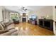Bright living room featuring hardwood floors, fireplace, ceiling fan, and recessed lighting at 1133 Heritage Greens Dr, Wake Forest, NC 27587