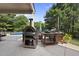 Poolside outdoor kitchen featuring a pizza oven and prep area for entertaining at 1133 Heritage Greens Dr, Wake Forest, NC 27587