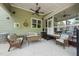 Relaxing screened patio with wicker seating and ceiling fan for outdoor comfort at 1133 Heritage Greens Dr, Wake Forest, NC 27587