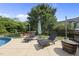 Outdoor pool area featuring lounge chairs, an umbrella, and serene backyard views at 1133 Heritage Greens Dr, Wake Forest, NC 27587