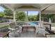 This spacious porch offers a serene view of the backyard pool and lush green trees at 1133 Heritage Greens Dr, Wake Forest, NC 27587