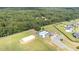 Aerial view of a community pool, sand volleyball court, and ample parking, bordered by a dense forest at 119 Florentino Ct, Clayton, NC 27527