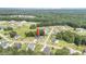 Wide aerial shot of a neighborhood featuring a blue home, surrounded by lush trees and other residences at 119 Florentino Ct, Clayton, NC 27527