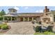 A view of the property's expansive brick patio area, complete with outdoor seating and fireplace at 119 Florentino Ct, Clayton, NC 27527