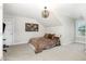 Cozy bedroom with a comfortable bed, unique light fixture and neutral wall-to-wall carpet at 119 Florentino Ct, Clayton, NC 27527