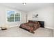 Neutral bedroom featuring a comfortable bed, plush carpeting and large window at 119 Florentino Ct, Clayton, NC 27527