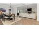 Dining room with modern lighting, stylish chairs, and an open view to the living area at 119 Florentino Ct, Clayton, NC 27527
