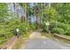 Inviting entrance path with natural surroundings, complemented by lush greenery and a quaint fence at 119 Florentino Ct, Clayton, NC 27527