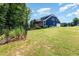 Exterior of a two-story home with screened porch, wooden deck, large lawn and landscaping at 119 Florentino Ct, Clayton, NC 27527