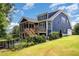 Exterior view of two-story home with a screened porch, wooden deck, and well-maintained yard at 119 Florentino Ct, Clayton, NC 27527