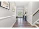 Inviting foyer featuring wood floors, wainscoting, and decoratively framed art that add a welcoming touch at 119 Florentino Ct, Clayton, NC 27527