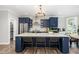 Spacious kitchen featuring an island with seating, modern appliances, and stylish lighting at 119 Florentino Ct, Clayton, NC 27527