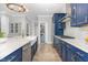 Well-equipped kitchen with blue cabinetry, stainless steel appliances, and ample counter space at 119 Florentino Ct, Clayton, NC 27527