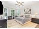 Bright main bedroom with a neutral color palette, large windows, and ceiling fan at 119 Florentino Ct, Clayton, NC 27527