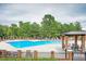 A beautiful community pool with lounge chairs, tables, and seating available for relaxing poolside at 119 Florentino Ct, Clayton, NC 27527